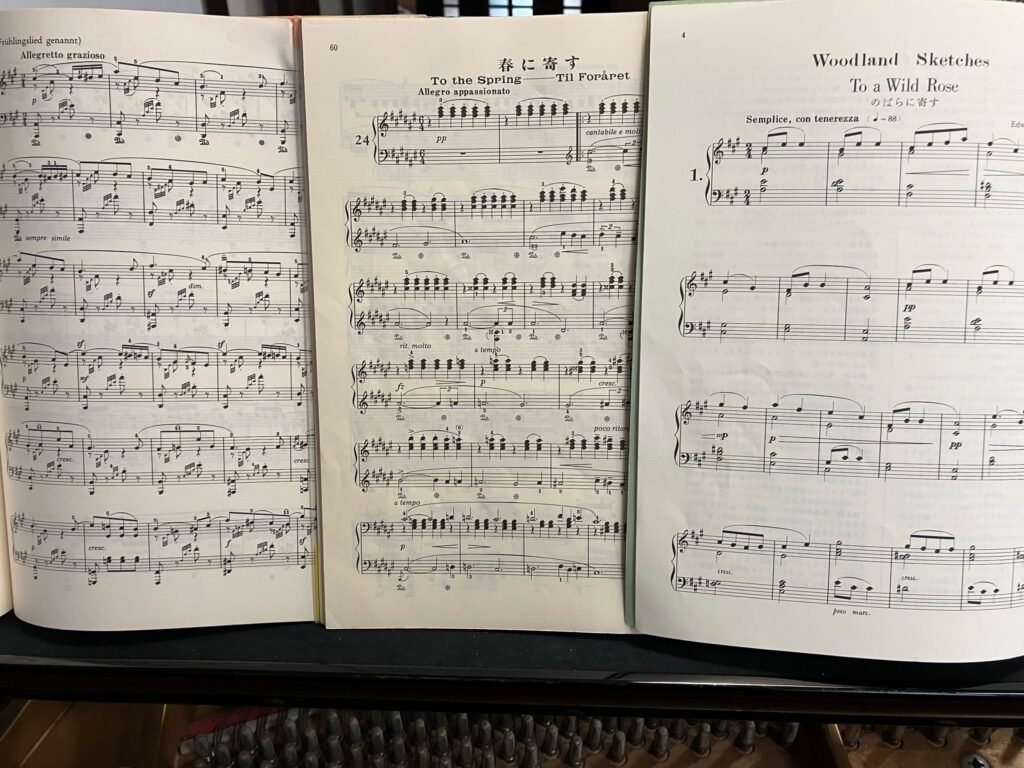 グリーグ「春に寄す」、マクダウェル「野ばらに寄す」、メンデルスゾーンの楽譜がピアノの上に並んでいる